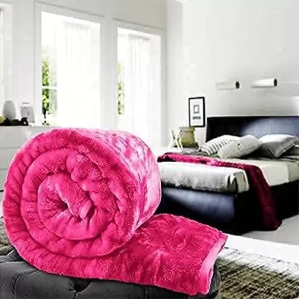 a pink blanket rolled up in a room